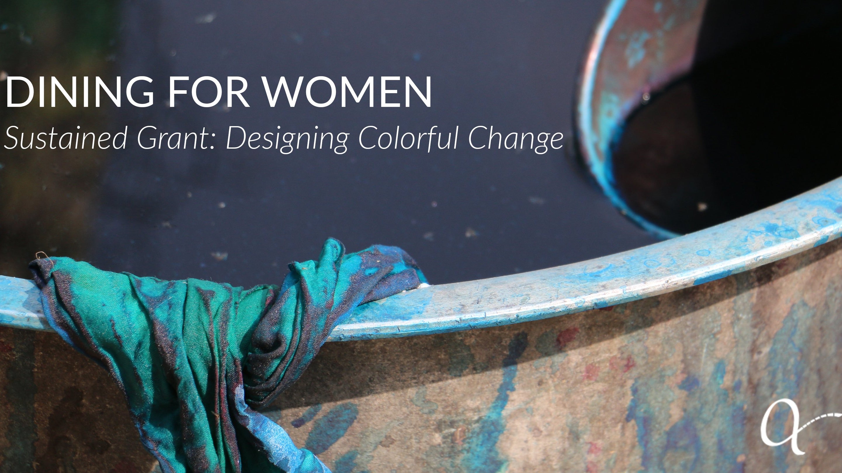 Bucket of dye with teal fabric hanging over the edge, celebrating the grant received from Dining For Women