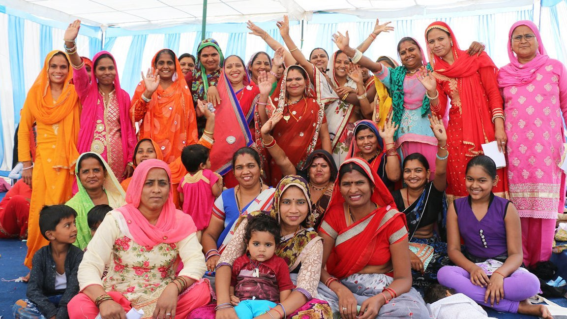 Anchal artisans dressed in saris gathered together to celebrate success and impact for Anchal in 2018