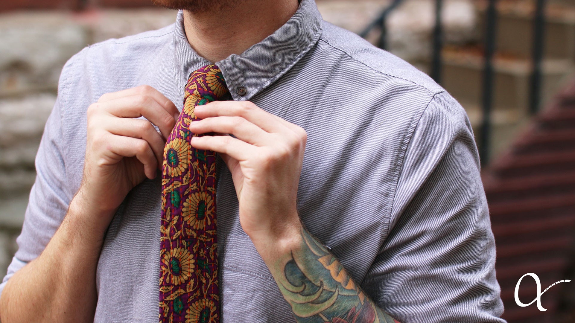 Man in a dress shirt accessorizing with an Anchal tie