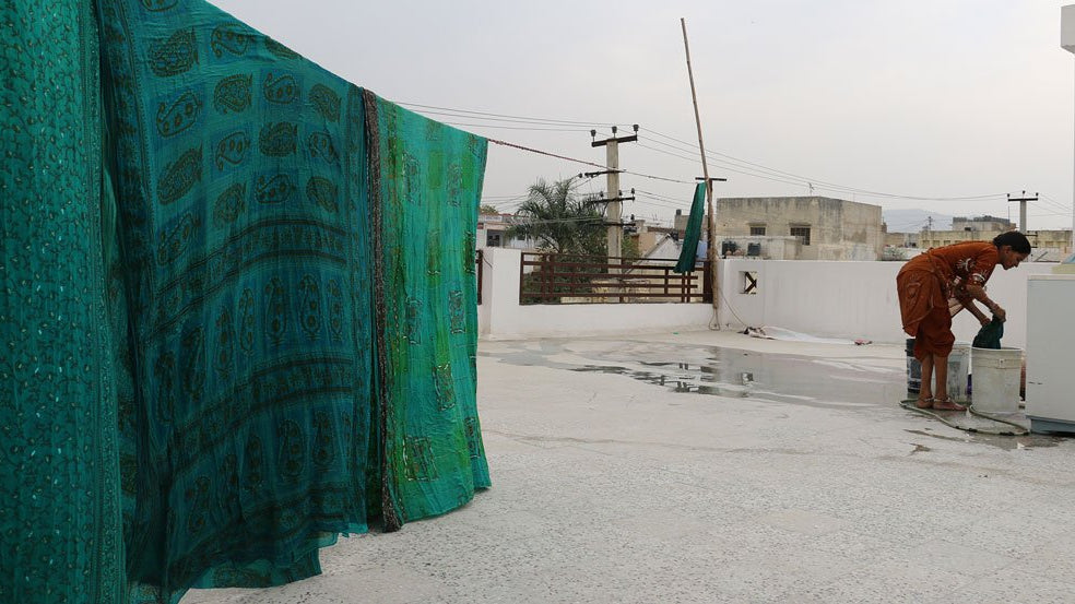 Vintage dyed fabrics hanging to dry outside