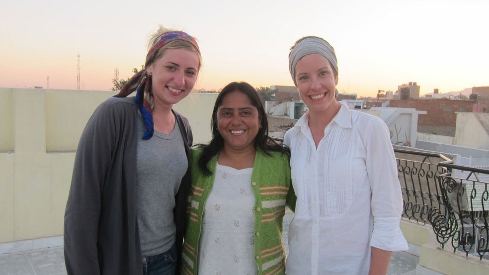 Colleen Clines and Manju on the rooftop smiling after a long day of work