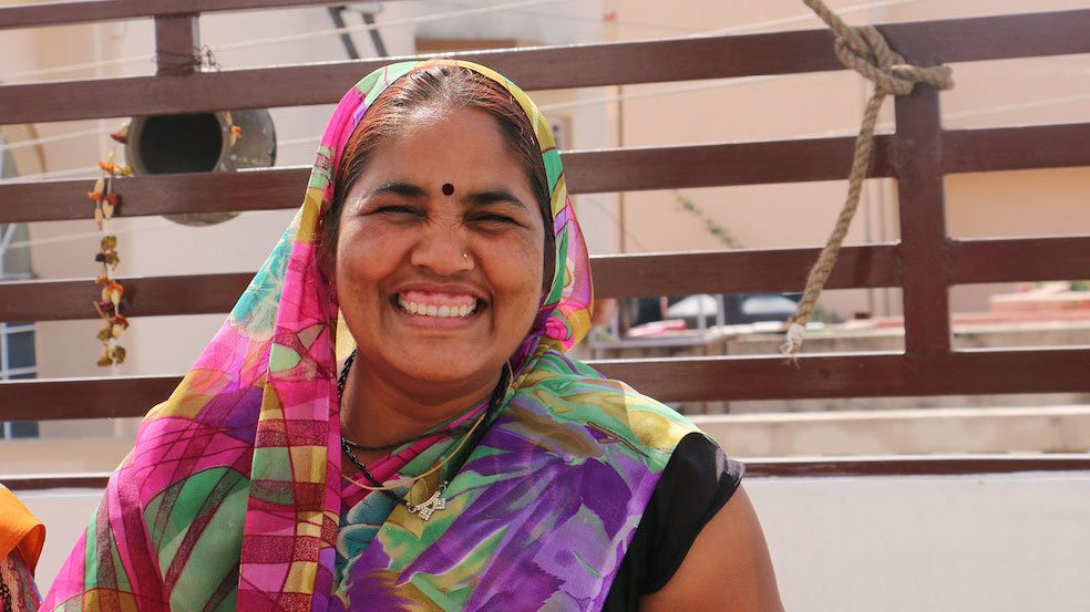 Maya, a female artisan, smiling with joy