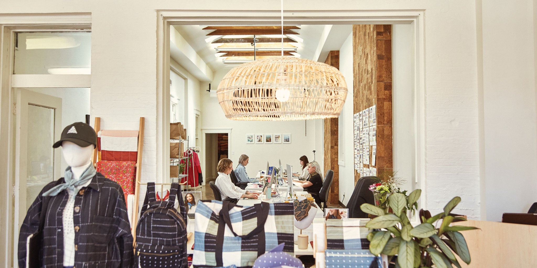 women in open concept working on desktop computers
