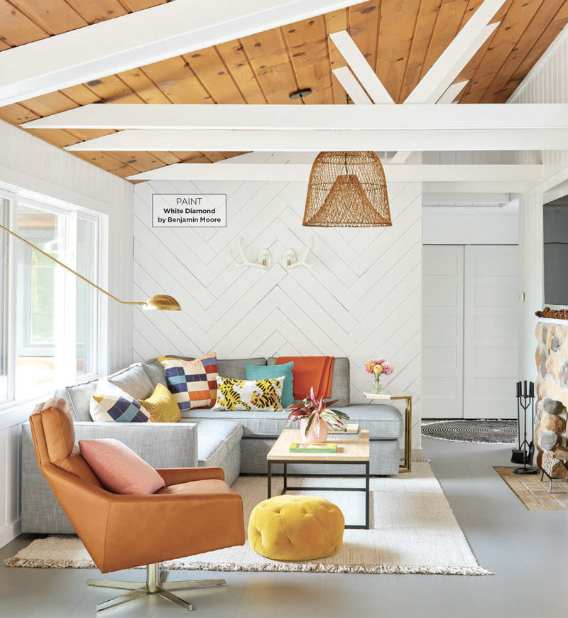 white and natural wooden living room with grey sectional with colorful throw pillows