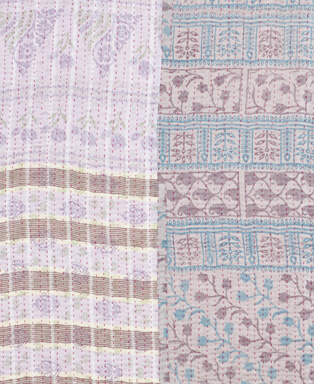 kantha quilt throw with a tag featuring the hand-stitched signature of the maker