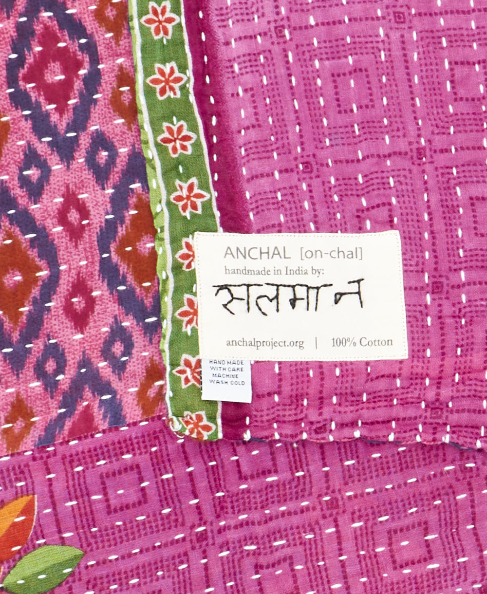 small kantha blanketwith signature of the maker on the tag