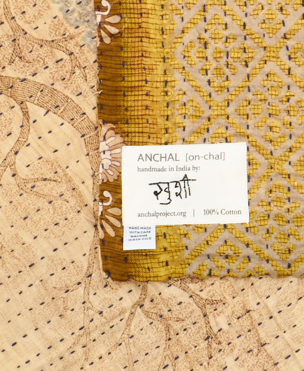 small kantha blanket with signature of the maker on the tag
