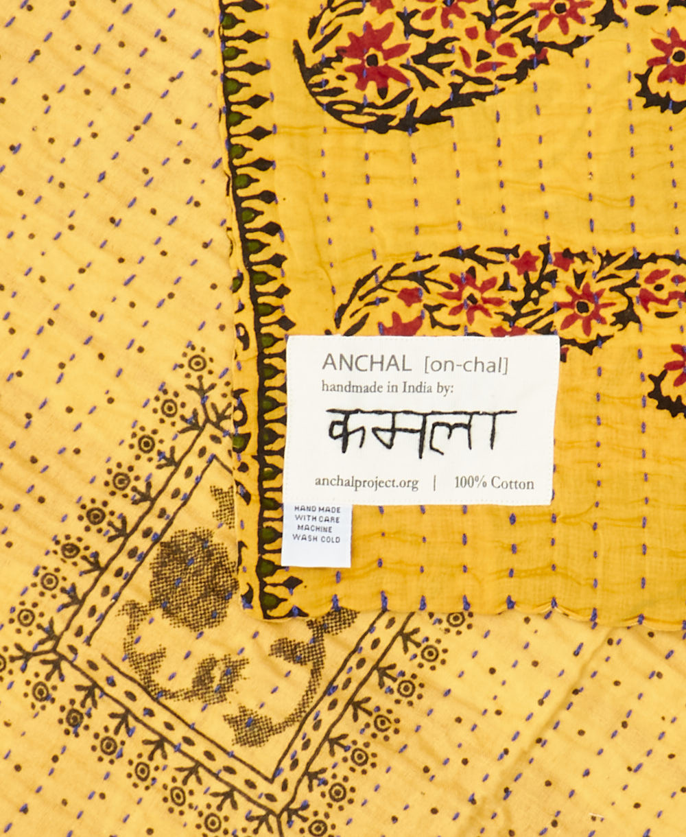 small kantha blanket with signature of the maker on the tag