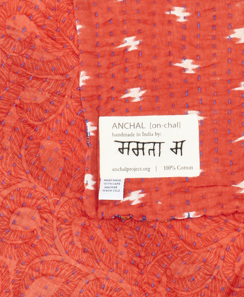 small kantha blanket with signature of the maker on the tag