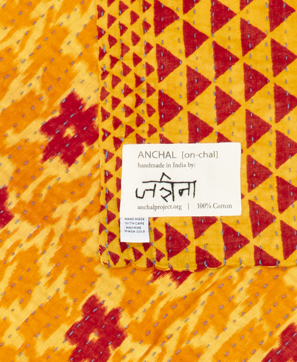 small kantha blanket with signature of the maker on the tag