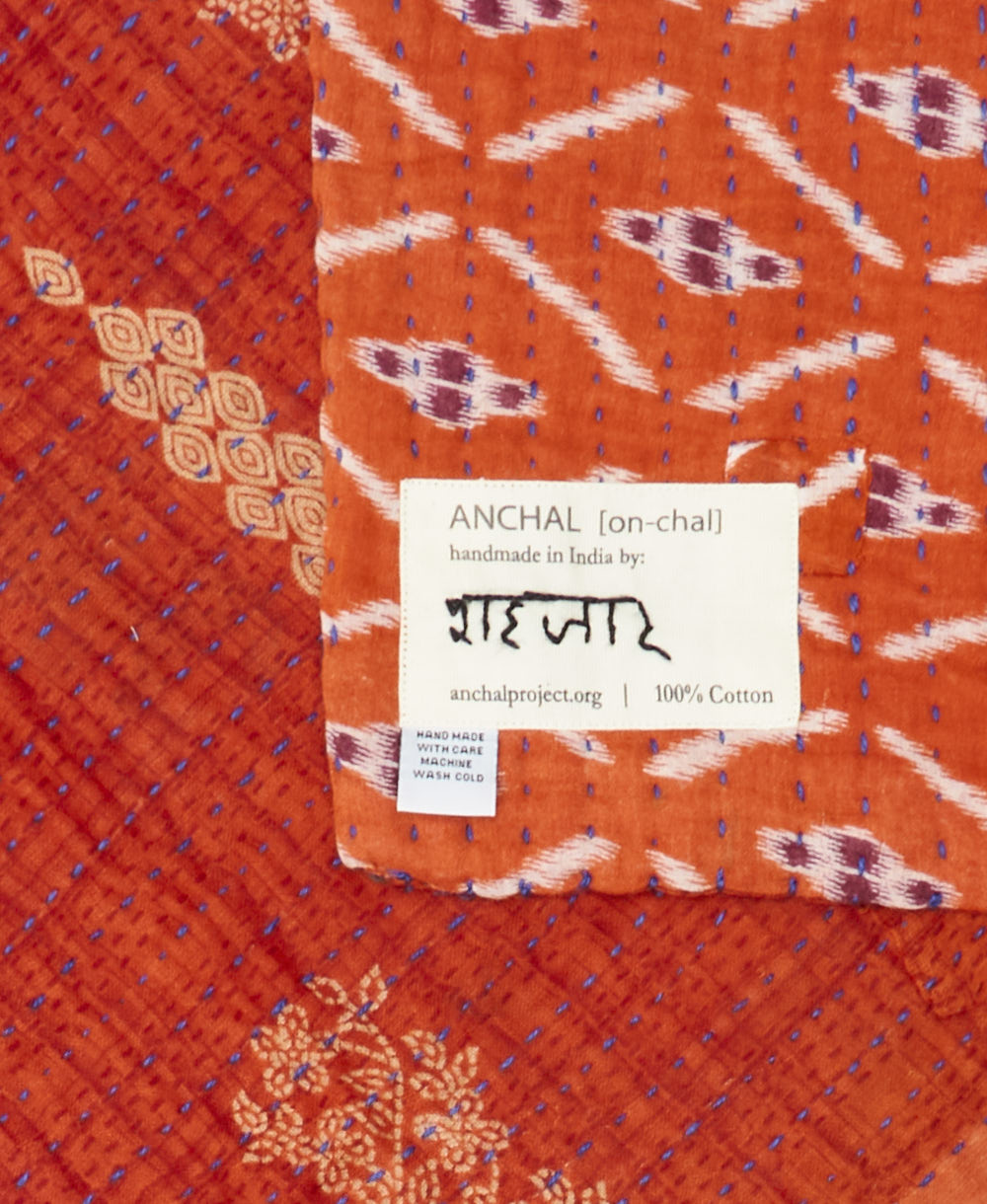 small kantha blanket with signature of the maker on the tag