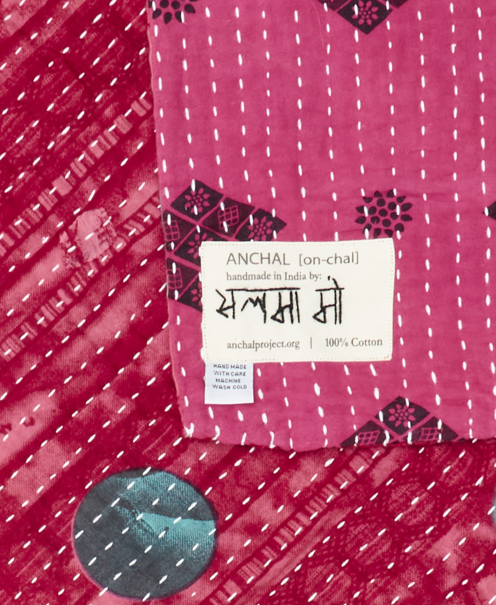 small kantha blanket with signature of the maker on the tag