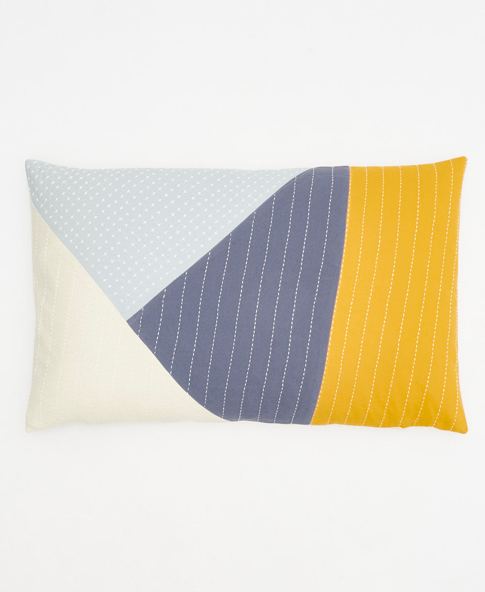 Color-blocked pillow with geometric pattern on a white background