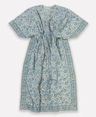 organic cotton kaftan in a blue and green floral print with a slit neckline, open sleeves and beaded waist ties