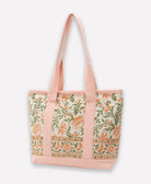 mini tote in light pink and green floral with pink canvas straps and exterior pockets