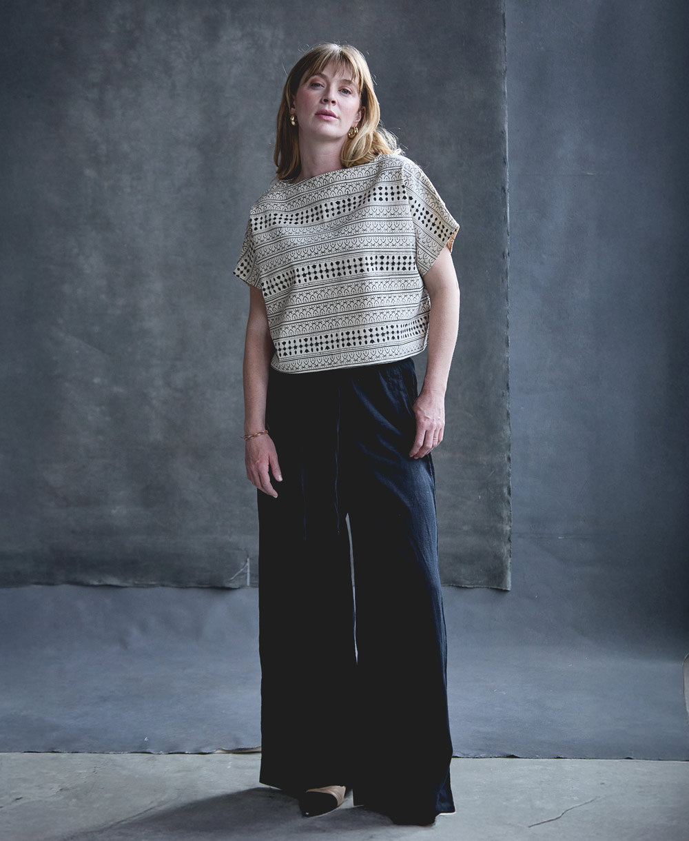 woman wearing structured graphic crop top in black and white block print design handmade from 100% organic cotton