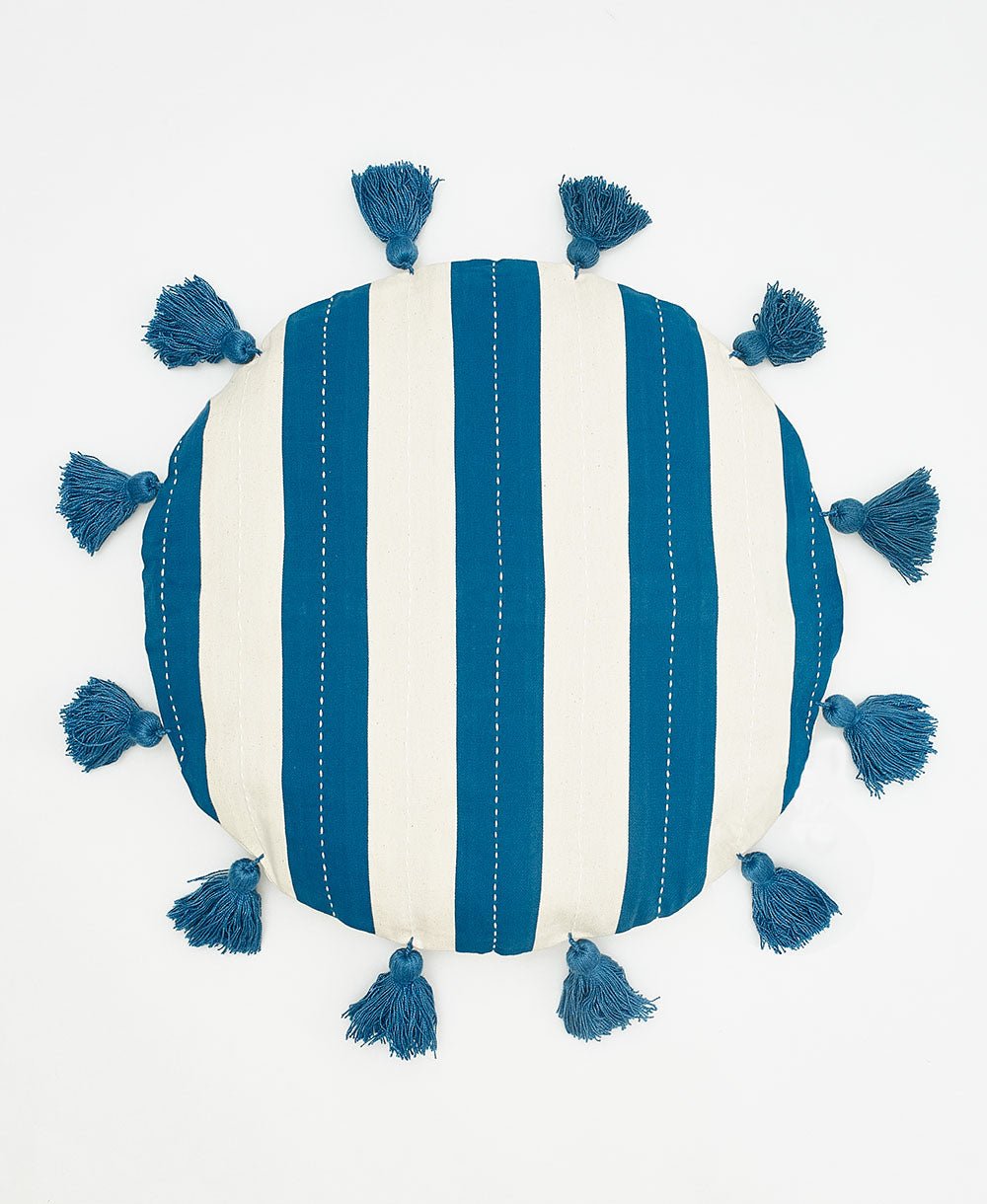 Striped pillow with blue tassels on a white background