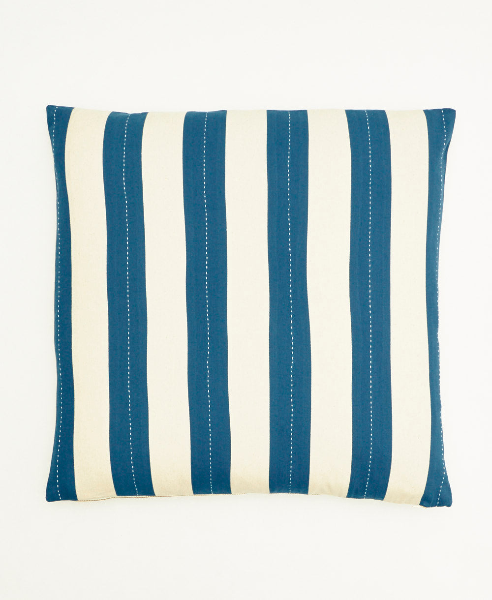 Striped pillow with blue and white vertical stripes on a white background