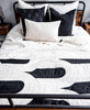 black and white bedding with matching pillow arrangement made from organic cotton