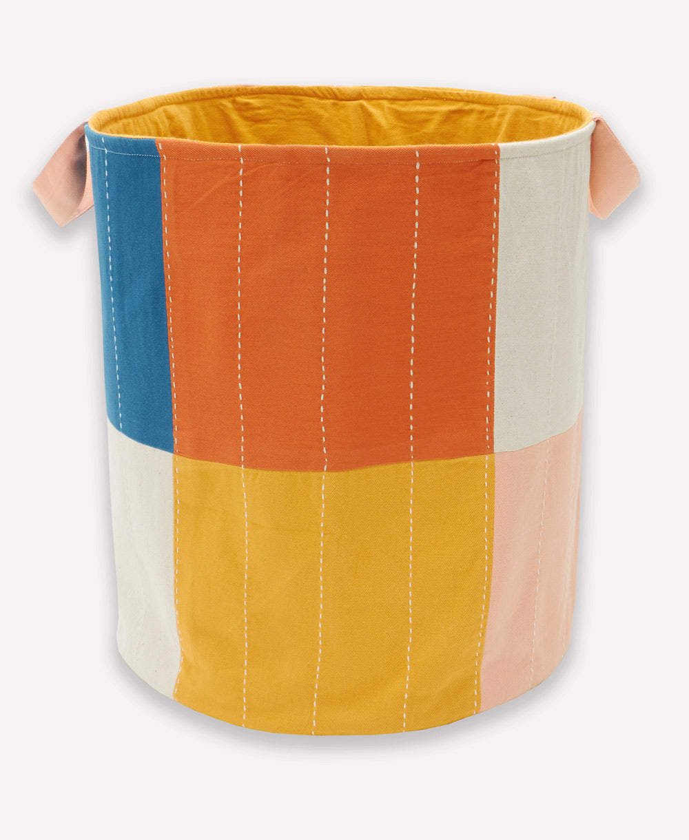 Colorful fabric basket with handles on a white background