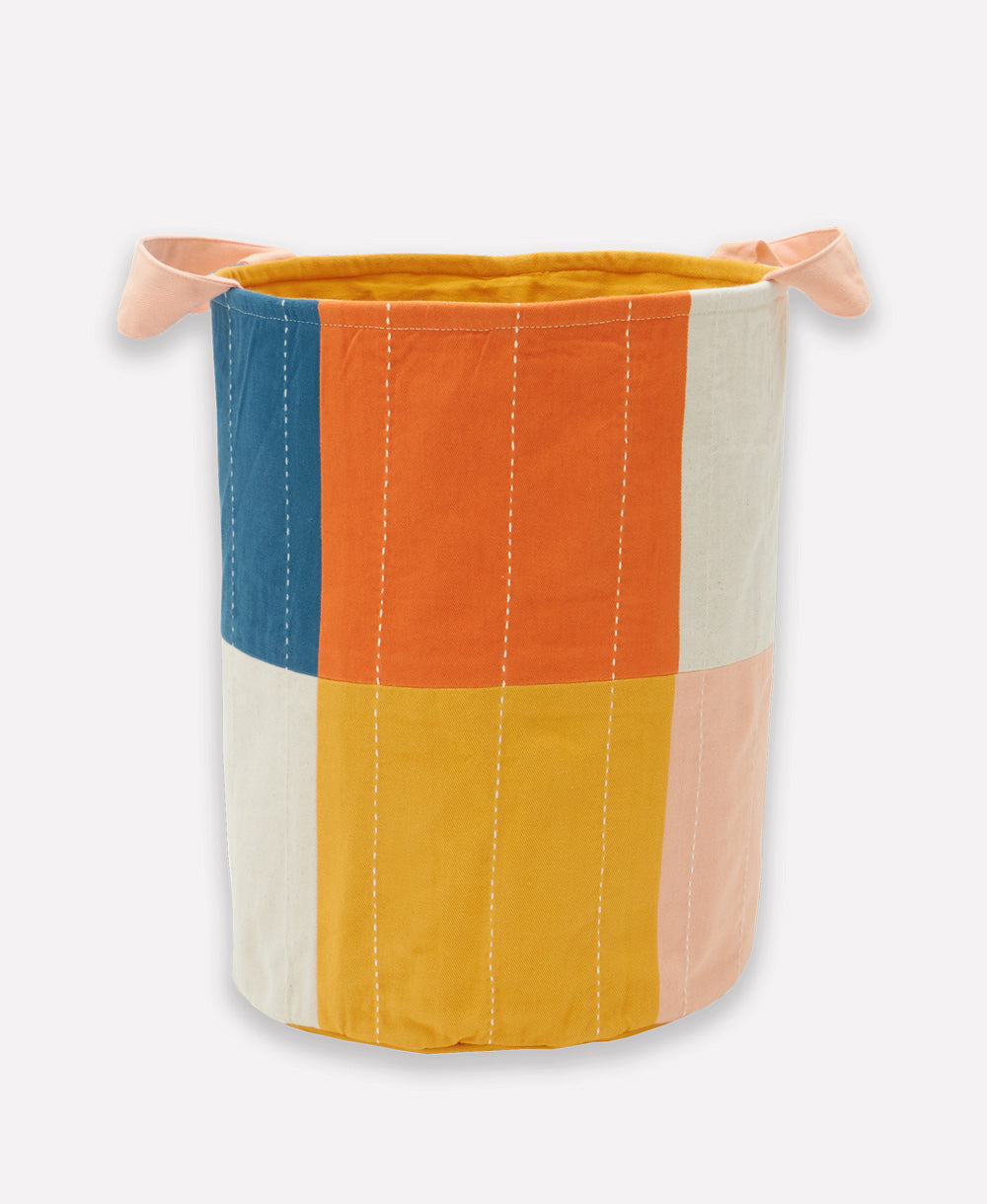 Colorful fabric basket with a striped pattern on a white background