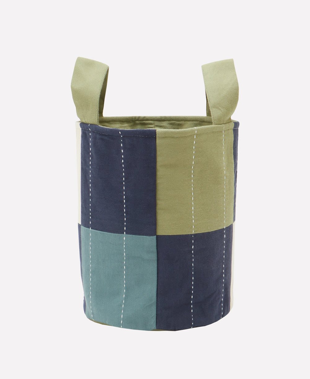 Multicolored fabric basket with handles on a white background
