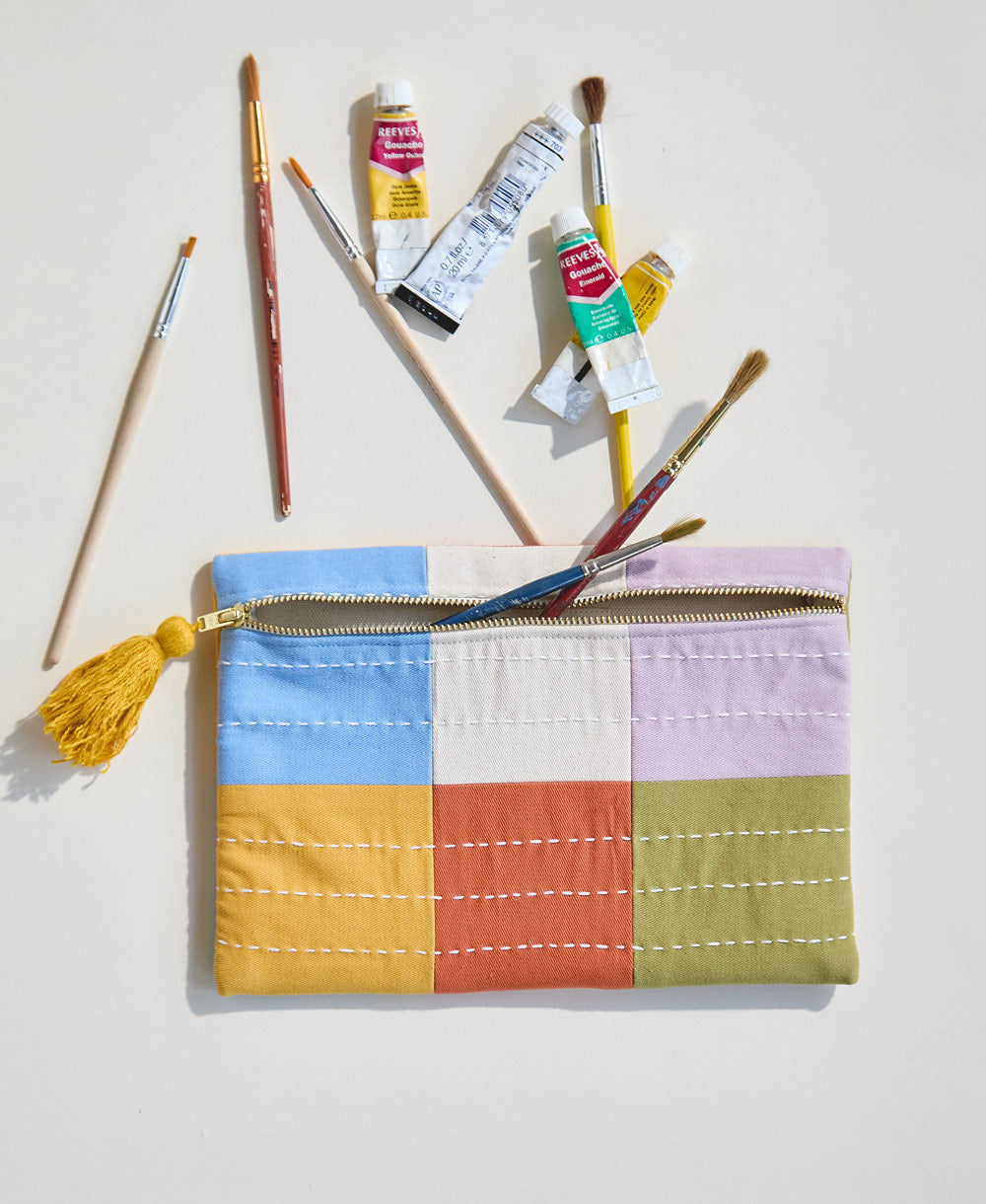 cloud blue checkered pouch with art supplies spilling out