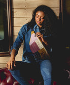 woman wearing colorful lilac checkered sling bag handmade in India from organic cotton