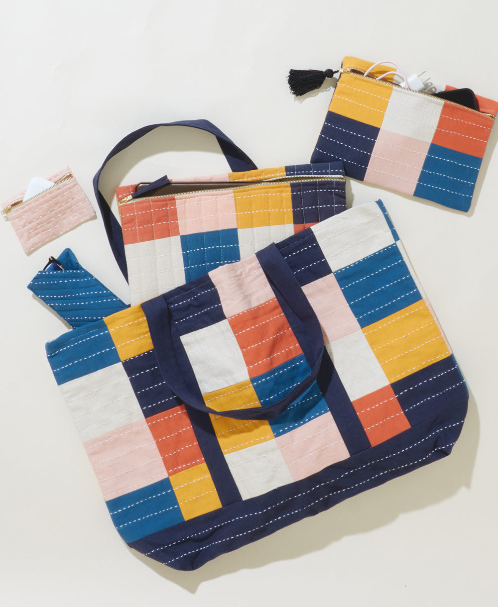 rainbow checkered tote bag with matching small pouches on a white background