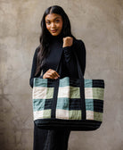 woman carrying sage green checkered tote in sage green, spruce green and black