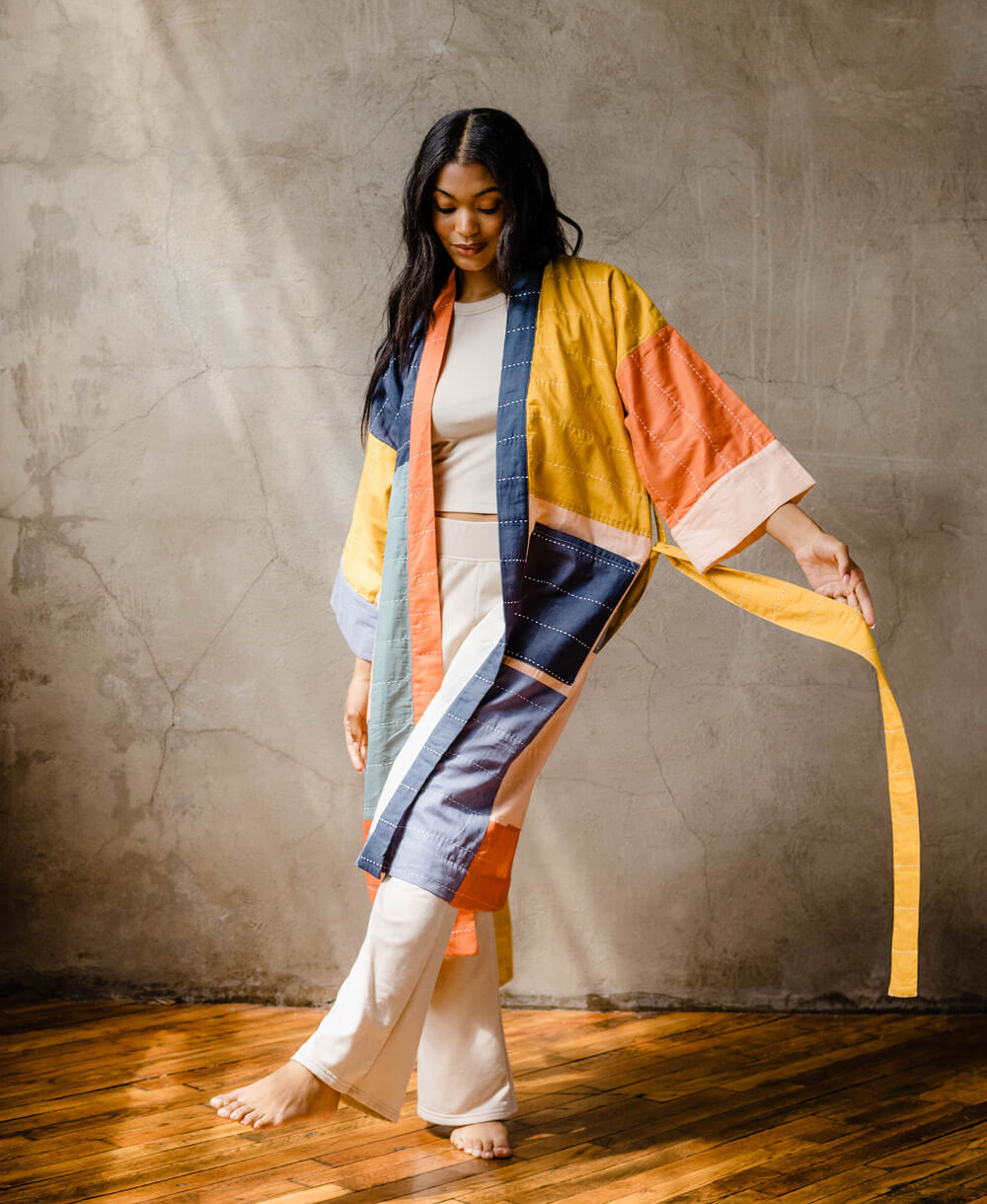 woman wearing organic cotton robe in colorful coloblock design with removable waist tie