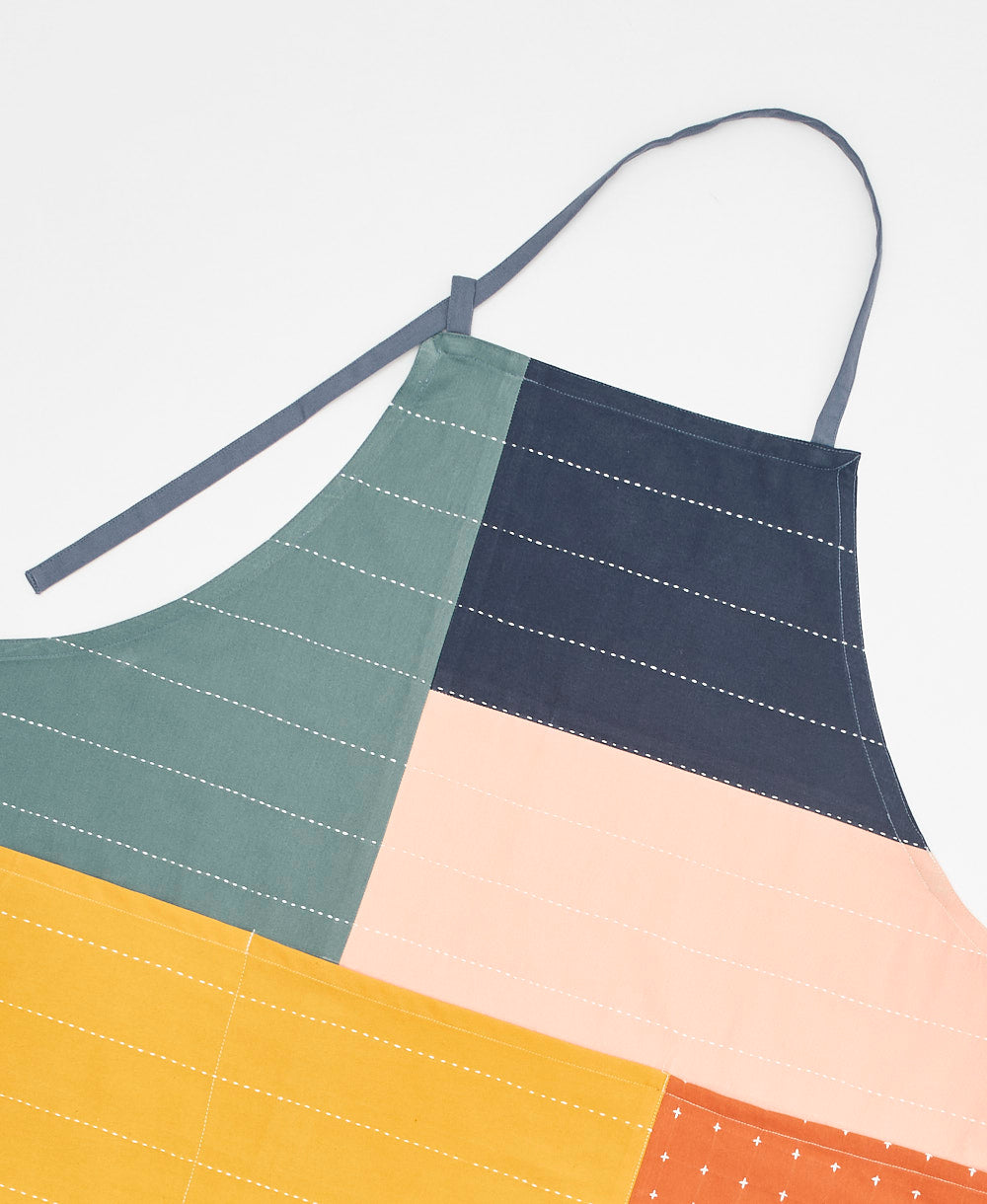Colorful apron with geometric pattern on a light gray background
