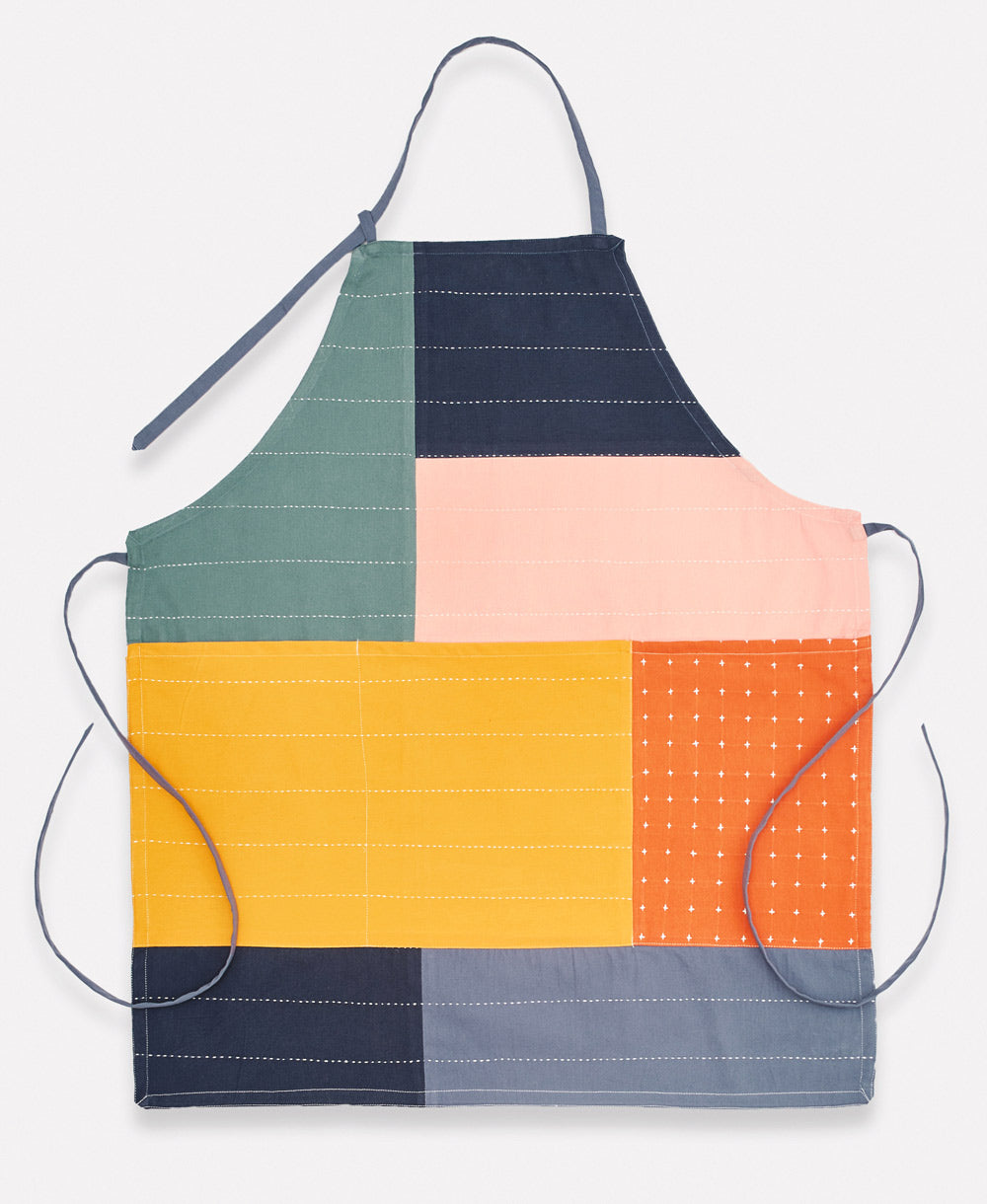 Colorful quilted apron with geometric pattern on a white background