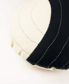 Close-up of a black and white quilted fabric edge on a white background