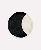 black and white round pillow with bold contrasting stitching