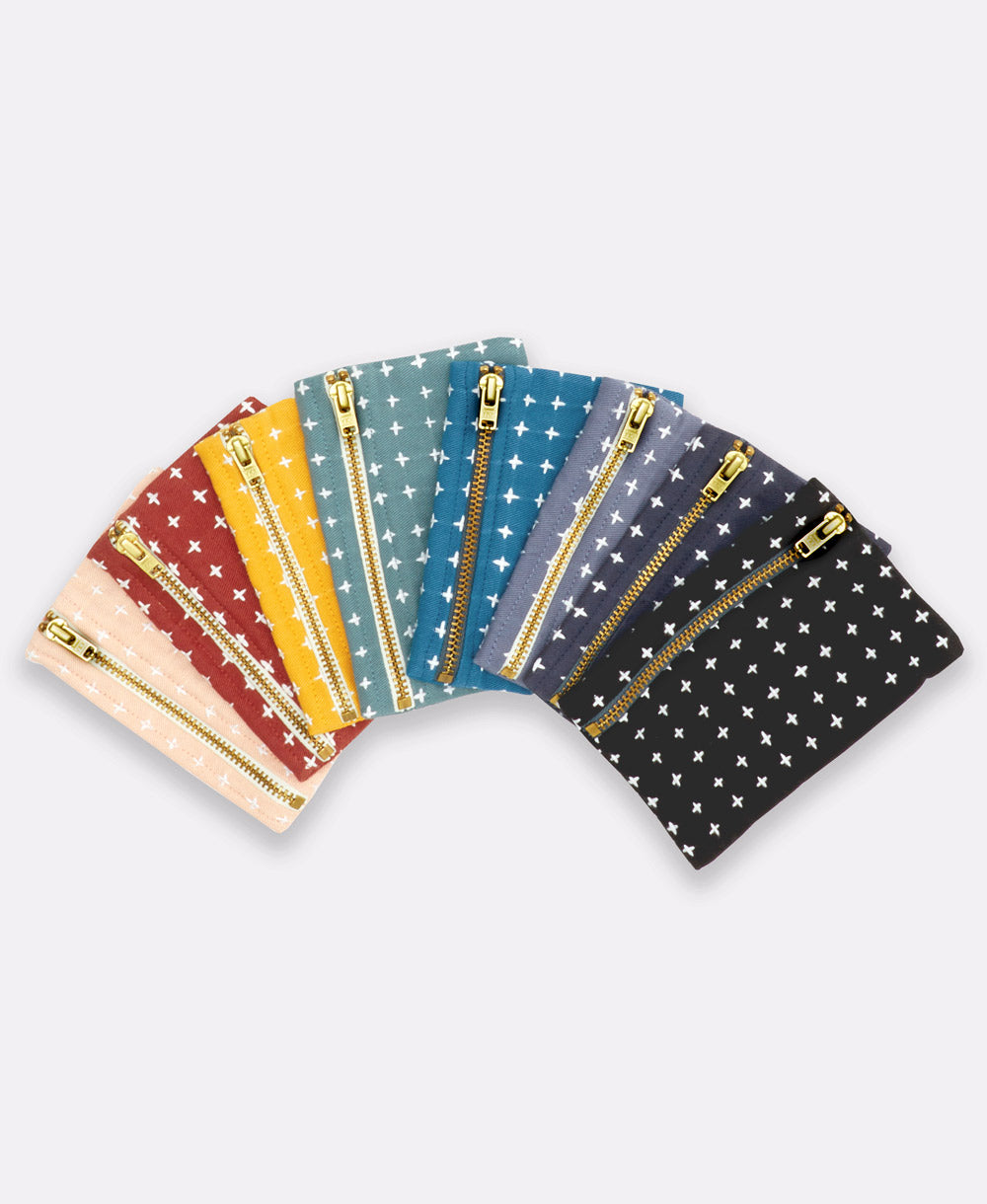 fan of a rainbow of cross-stitch coin purses