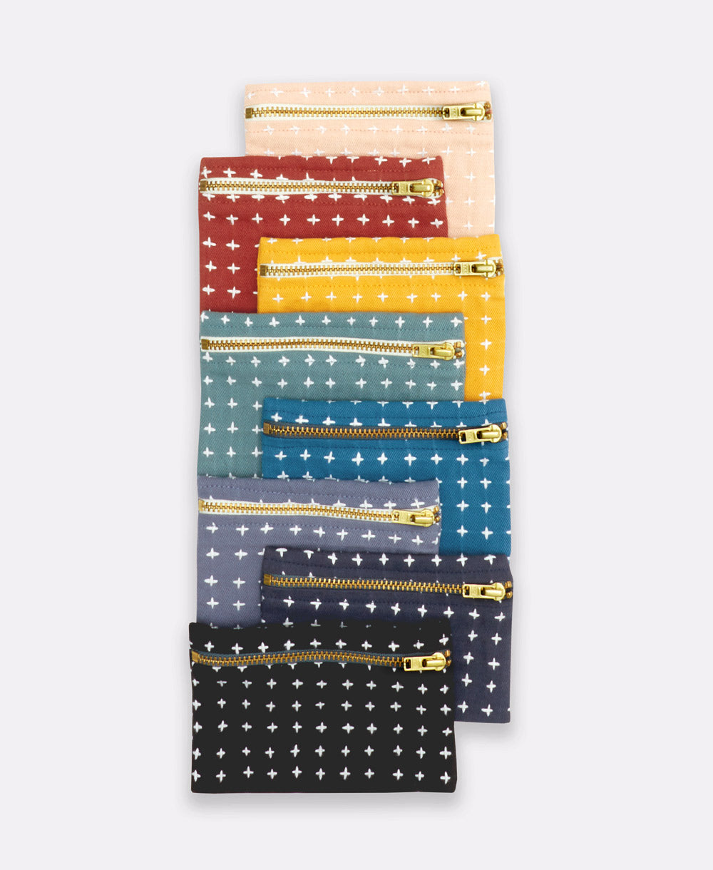array of colors of cross-stitch coin purses made in India from 100% organic cotton