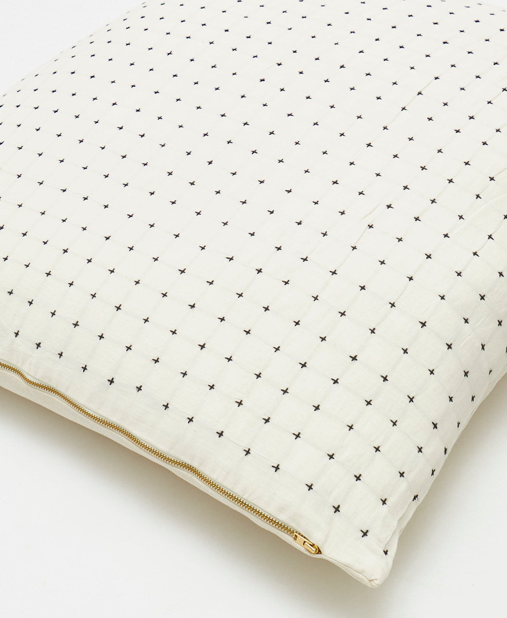 close up detail of white euro sham with black cross-stitch embroidery