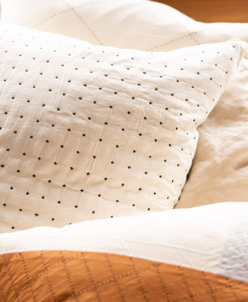 Close-up of a textured fabric with star patterns on a neutral background