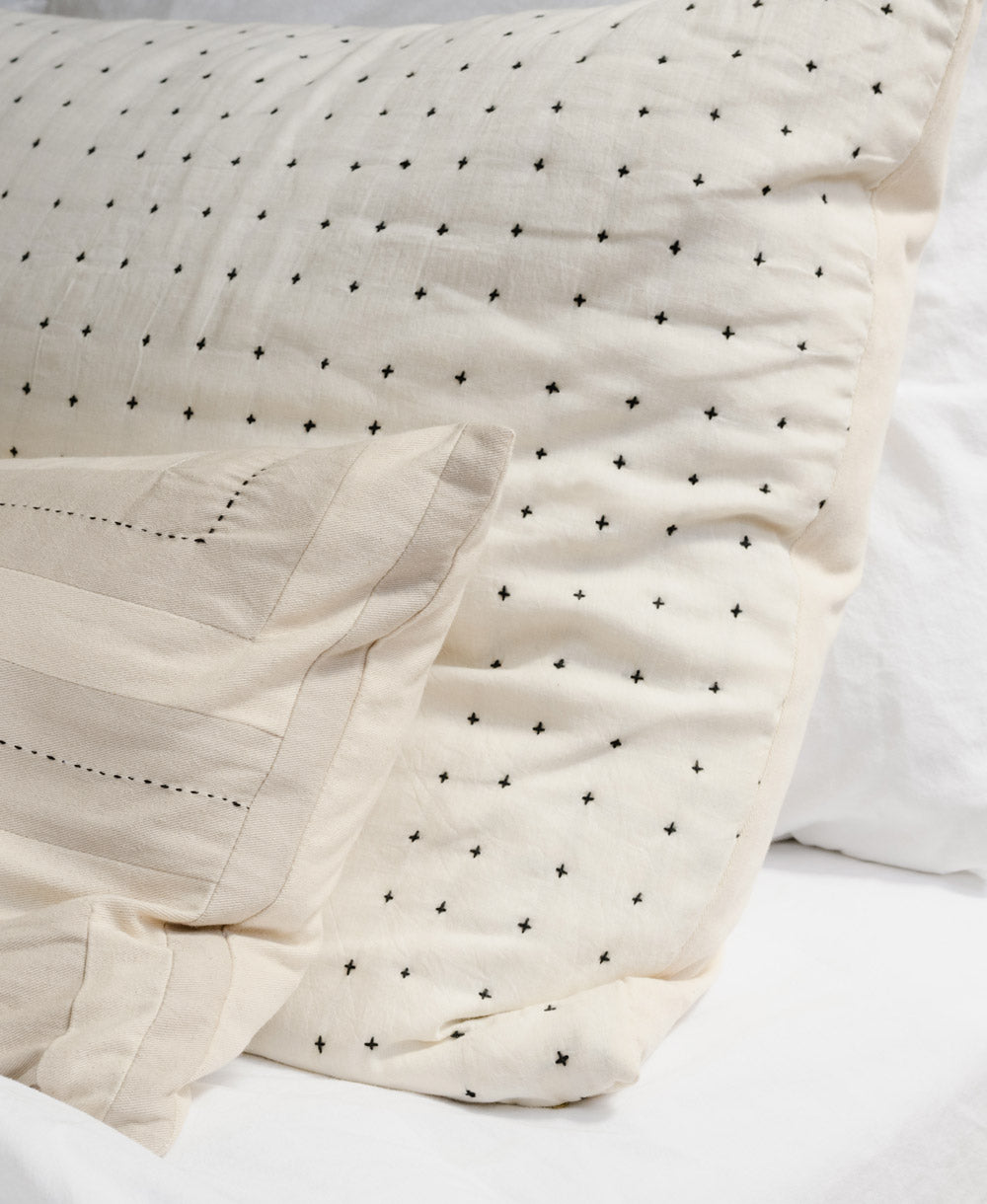close up detail of cross-stitch embroider on cross-stitch pillow sham