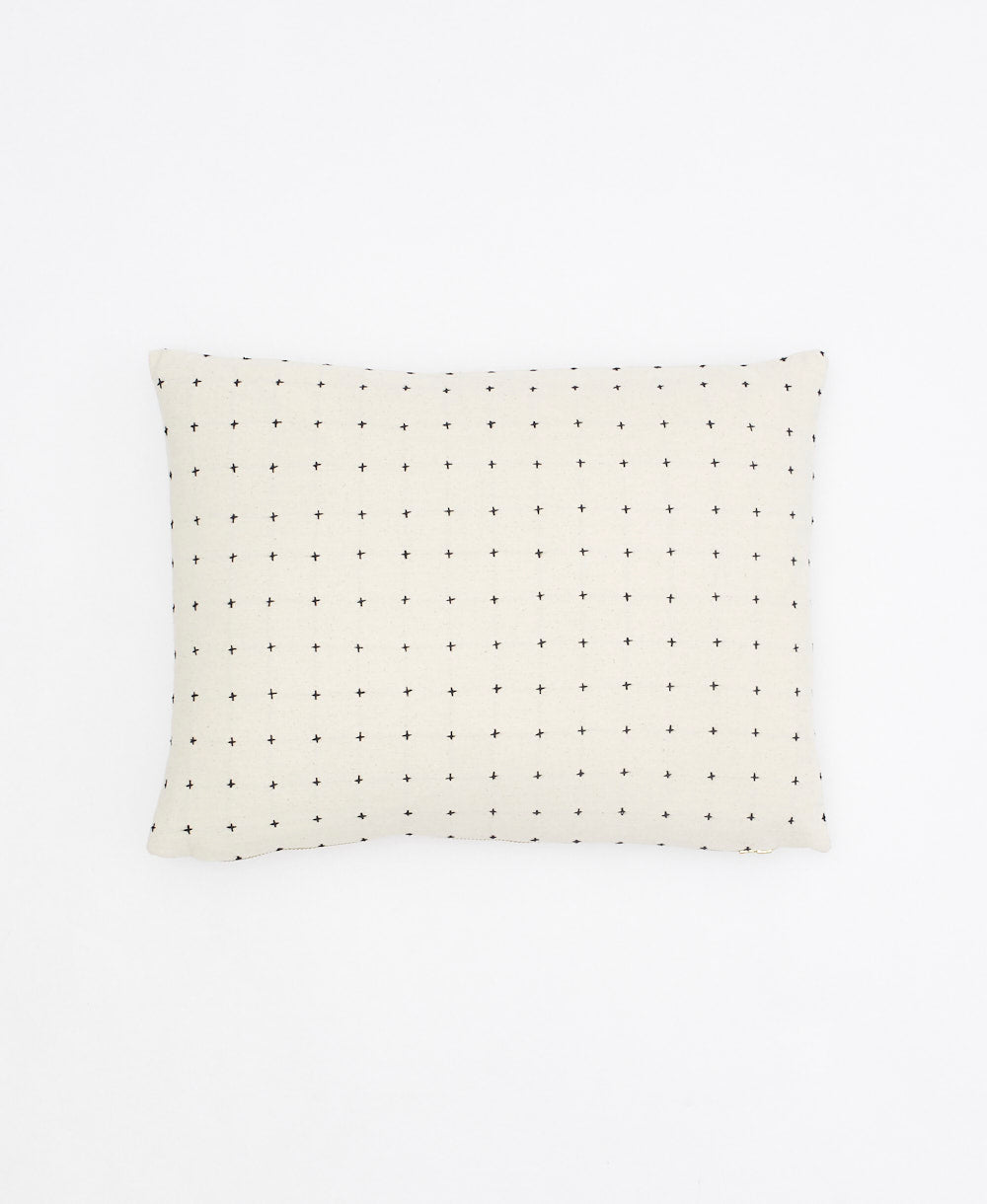 rectangular pillow in white with black cross-stitch embroidery