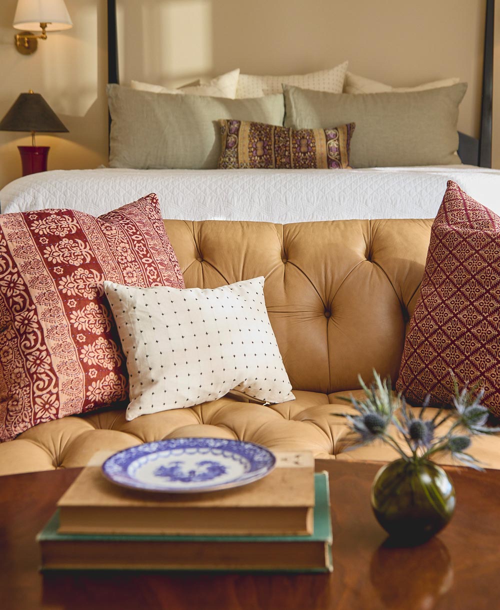 Cozy living room with a brown sofa, decorative modern throw pillows, and a coffee table