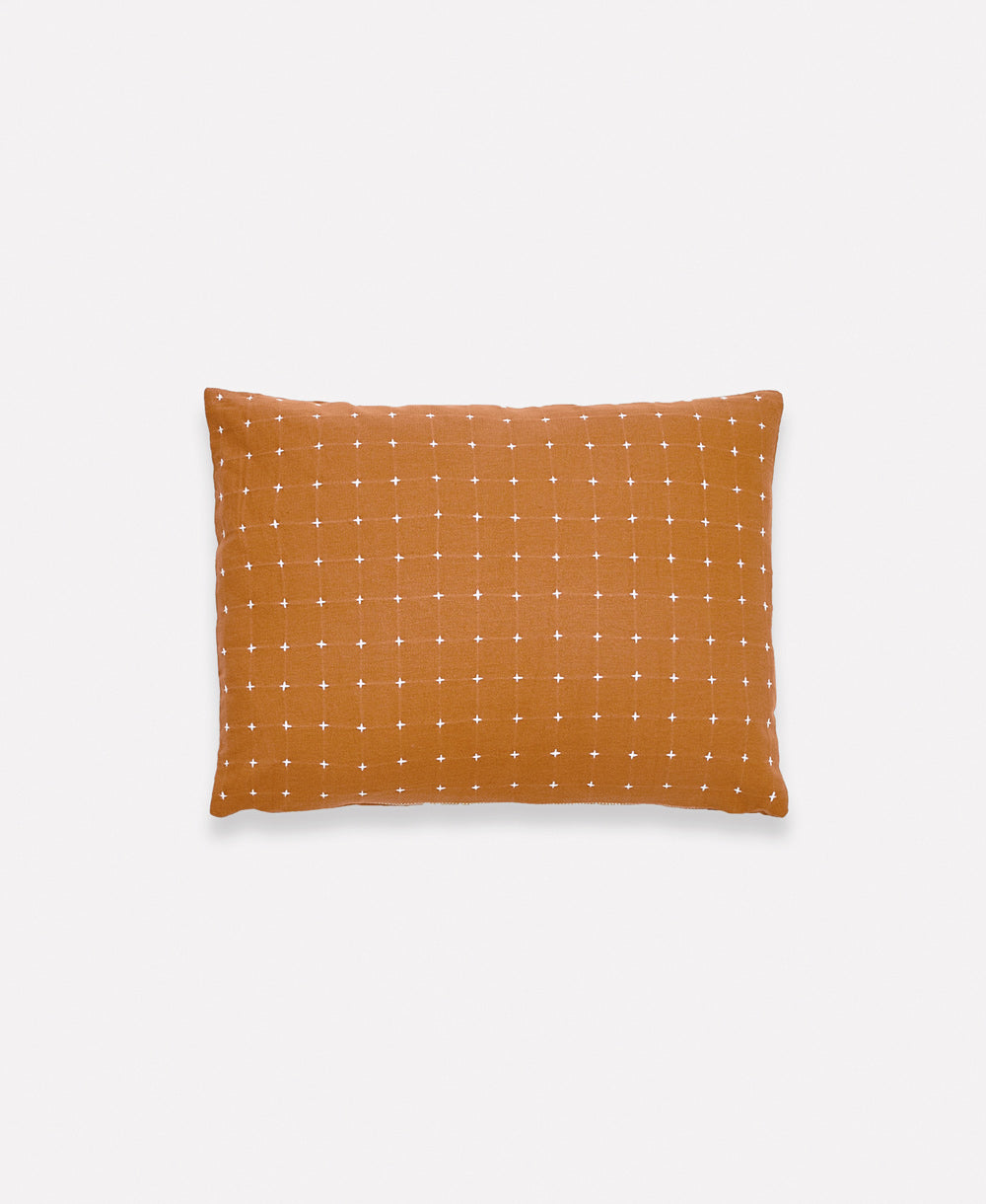 camel brown rectangular pillow with white cross-stitch embroidery handmade in India by women artisans