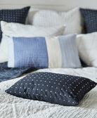Collection of patterned pillows on a bed