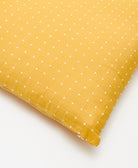 Yellow pillow with white star pattern on a white background