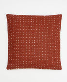 rust red and white cross-stitch throw pillow on white background