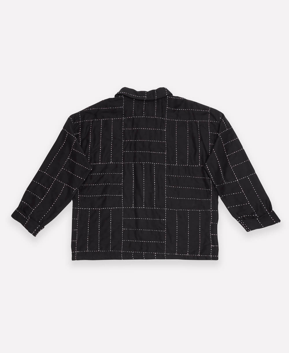 black quilted chore jacket in white cross-hatch embroidery pattern with button front