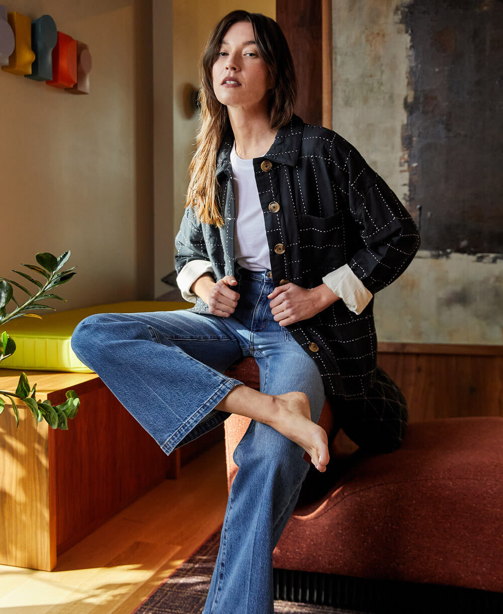 woman wearing black quilted chore jacket in cross-hatch pattern made from 100% organic cotton