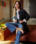woman wearing black quilted chore jacket in cross-hatch pattern made from 100% organic cotton