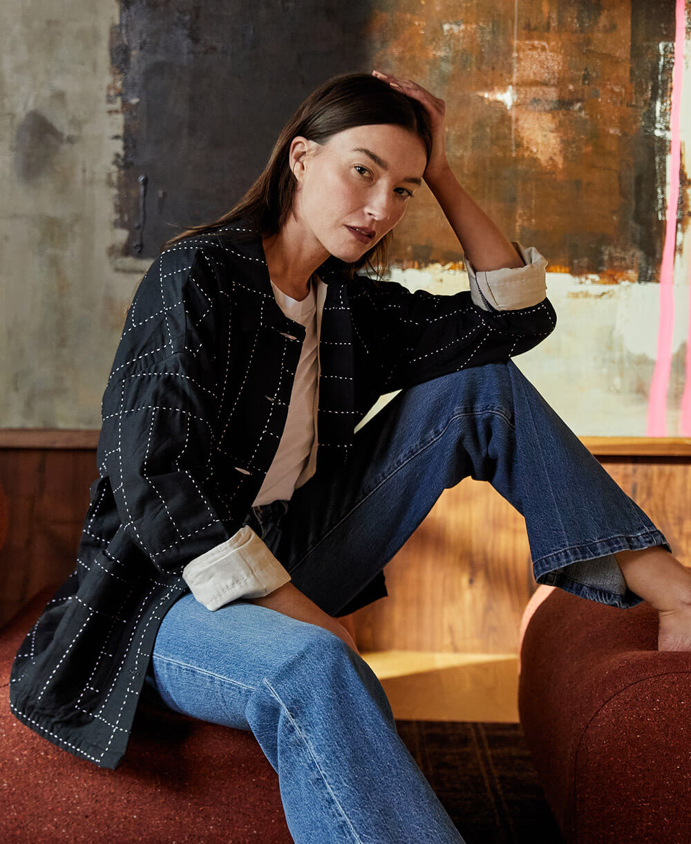 black quilted chore jacket with white cross-hatch embroidery